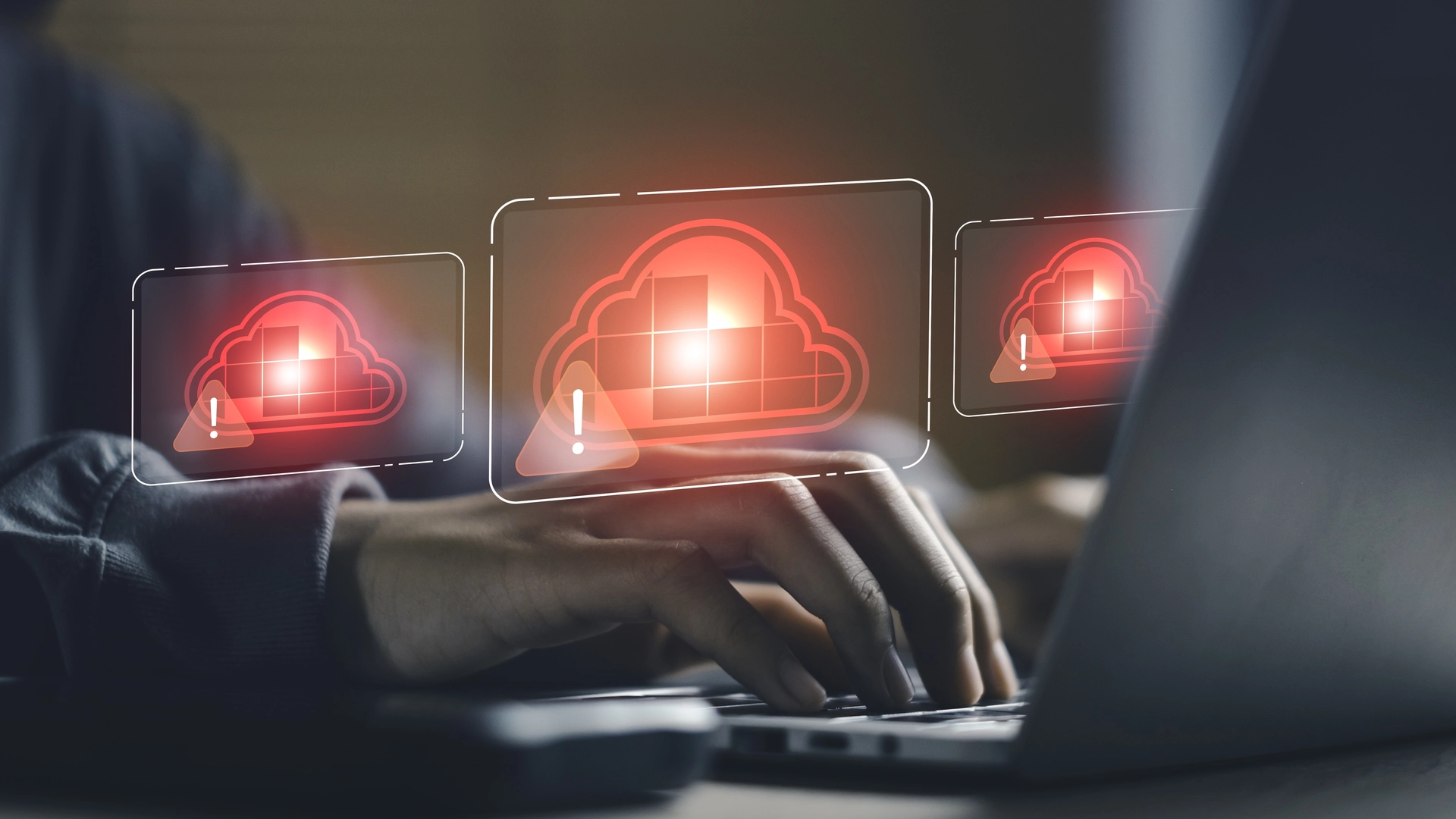 Engineer typing on a laptop with red cloud warning icons representing denied cloud software license checkouts